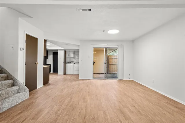 a kitchen with granite countertop a refrigerator stove top oven and sink