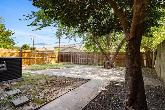an empty room with a ceiling fan and a window