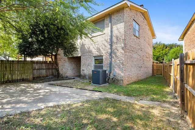 a view of a yard with wooden fence