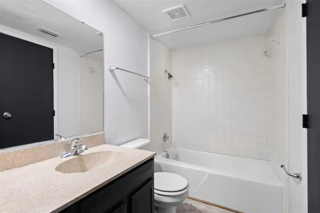 a bathroom with a sink a toilet and a bathtub