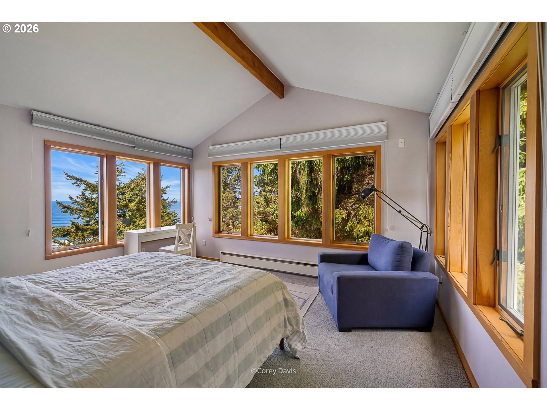 38295 Beulah Reed Road Nehalem, OR 97131 - Photo 28 of 42 a spacious bedroom with a large bed and a large window