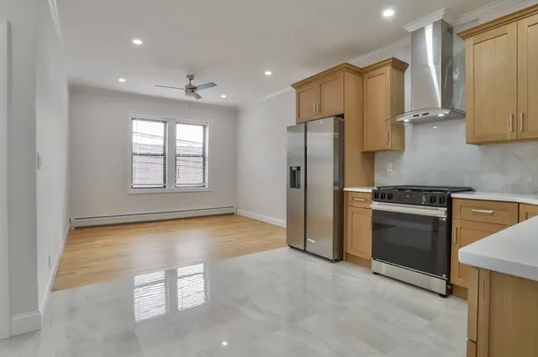 a kitchen with stainless steel appliances granite countertop a refrigerator and a stove top oven