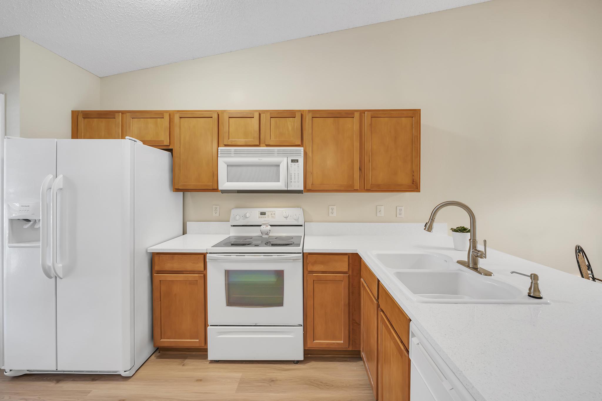 724 Ginger Mill Drive St. Johns, FL 32259 - Photo 12 of 54 a kitchen with stainless steel appliances granite countertop a sink stove and refrigerator
