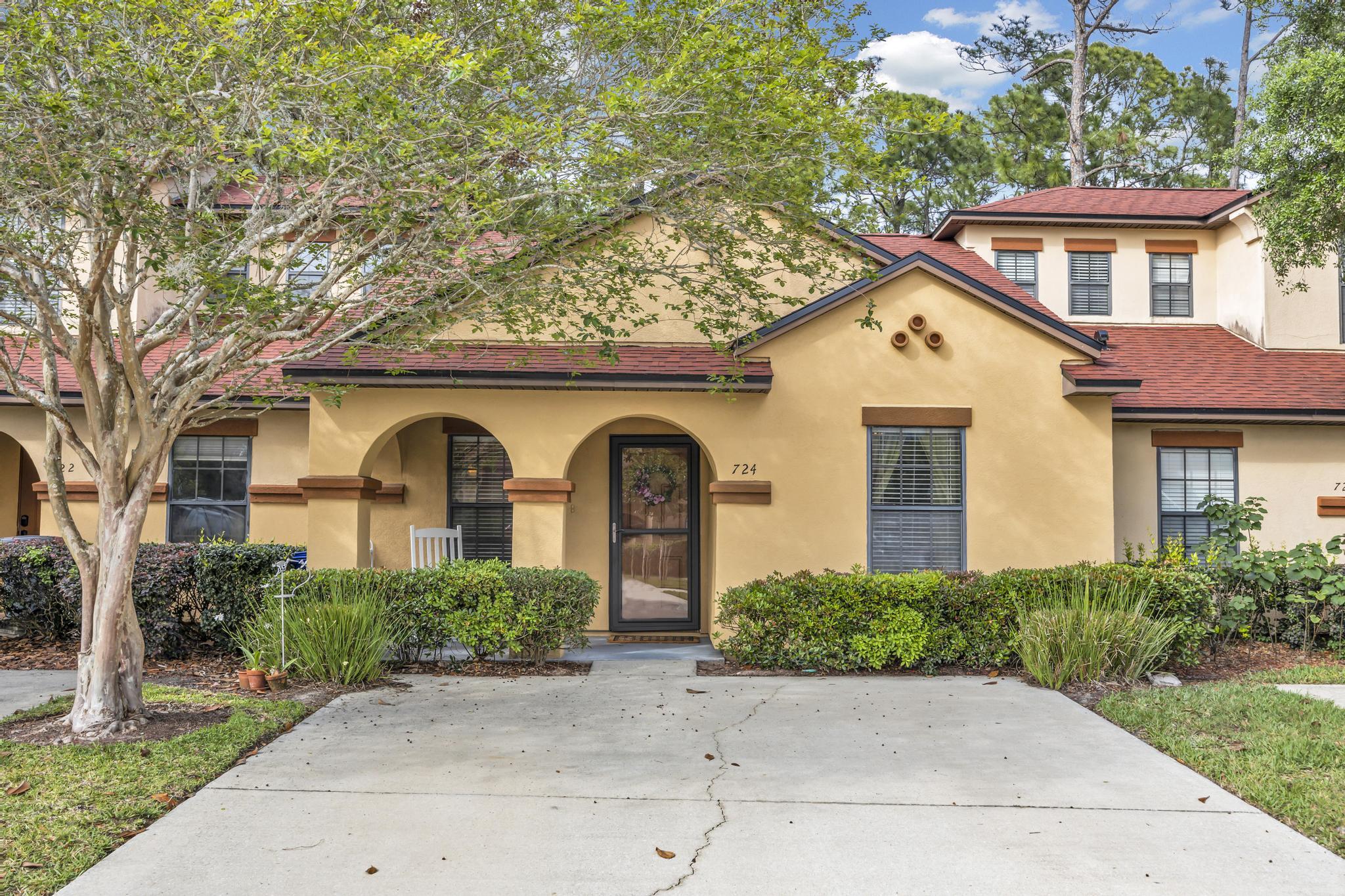 724 Ginger Mill Drive St. Johns, FL 32259 - Photo 2 of 54 a front view of a house with garden