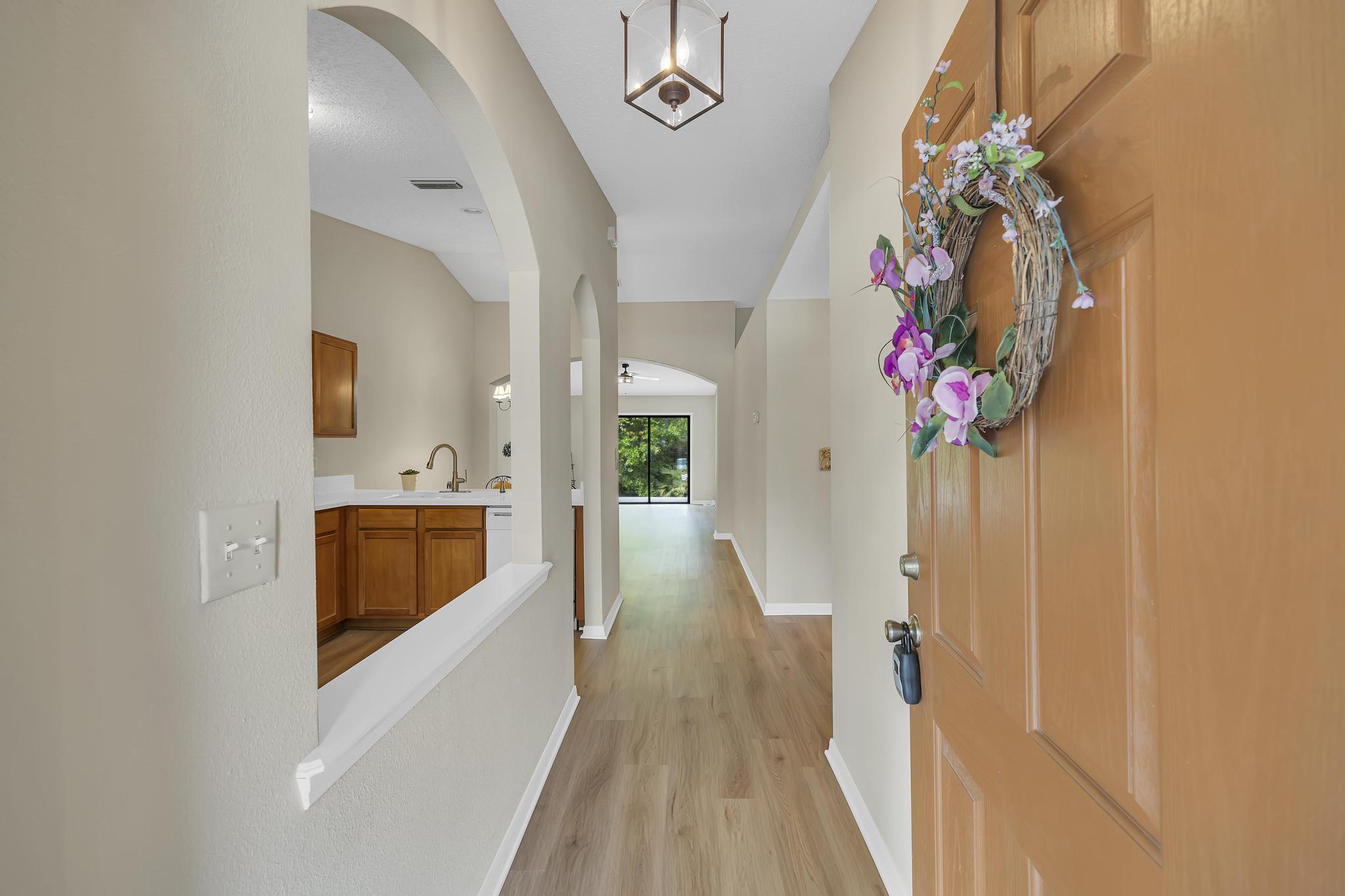 724 Ginger Mill Drive St. Johns, FL 32259 - Photo 5 of 54 a hallway with painting and flowers