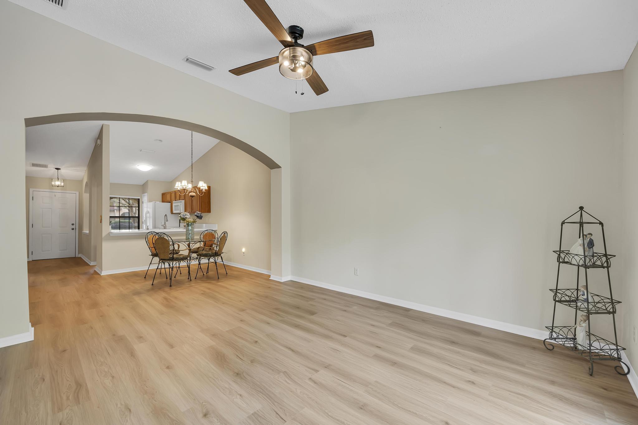 724 Ginger Mill Drive St. Johns, FL 32259 - Photo 7 of 54 a view of a livingroom with furniture and a table wooden floor