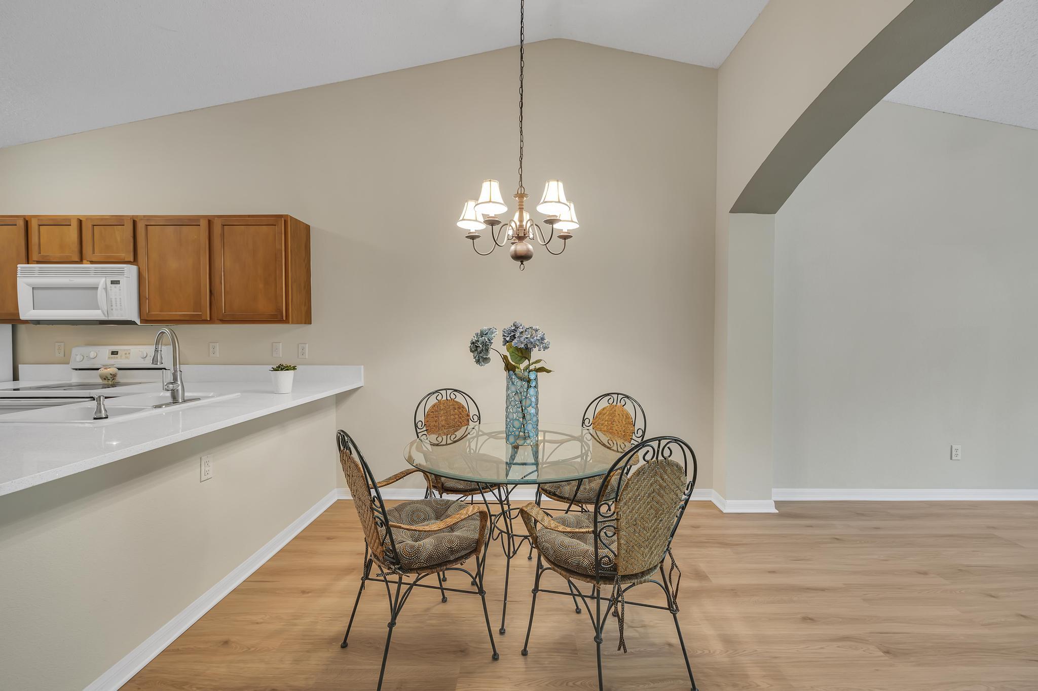 724 Ginger Mill Drive St. Johns, FL 32259 - Photo 10 of 54 a view of a dining room with furniture and chandelier