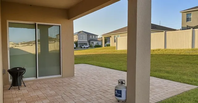 a view of a porch with a floor to ceiling windows and yard