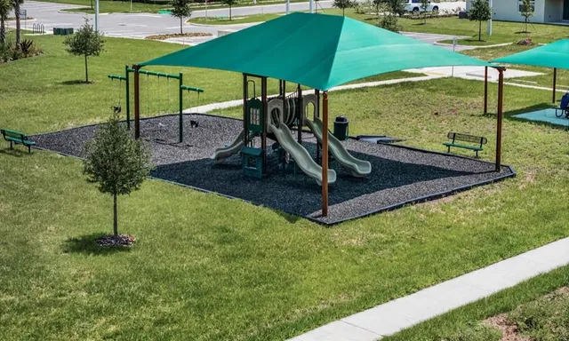a view of a backyard with table and chairs