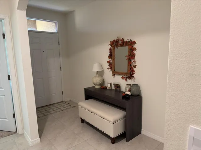 a bed room with furniture and a mirror