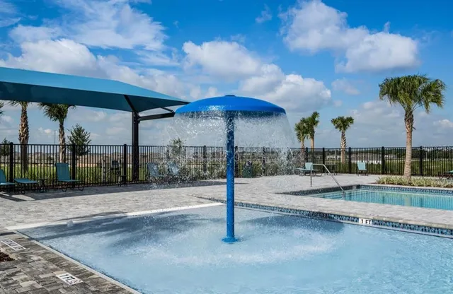 a view of a patio with a table and chairs under an umbrella