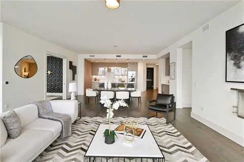 a living room with furniture and a floor to ceiling window