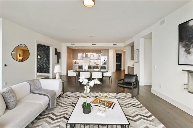 a living room with furniture and a floor to ceiling window