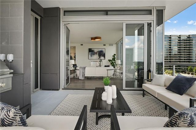 a large kitchen with stainless steel appliances kitchen island a large counter top a stove a chimney a sink and a refrigerator