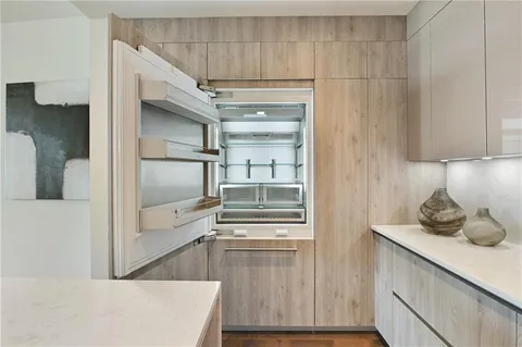 a living room with furniture and large windows with wooden floor