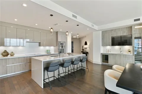 a bathroom with a double vanity sink a toilet and shower