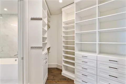 a view of walk in closet with white walls