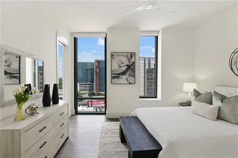 a view of a dining room with furniture and a potted plant