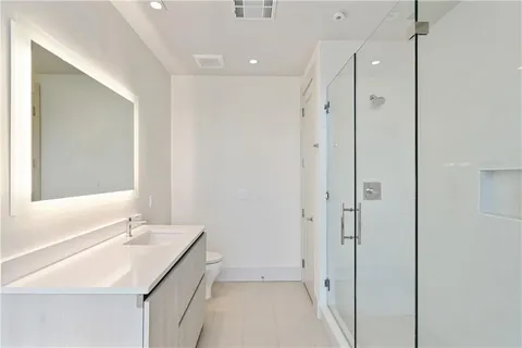 a dining hall with stainless steel appliances granite countertop a stove a refrigerator a oven a sink with island and chairs