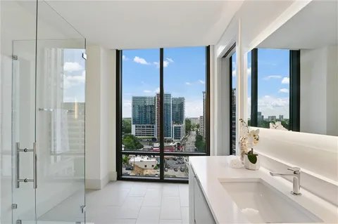 a living room with furniture and a floor to ceiling window