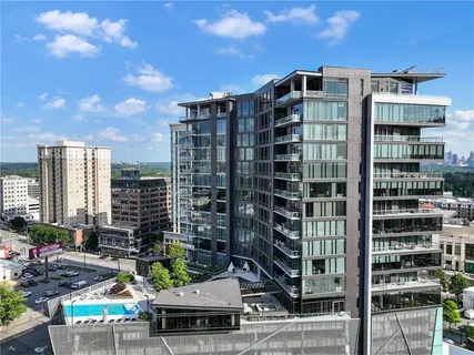 a living room with furniture and a dining table with kitchen view