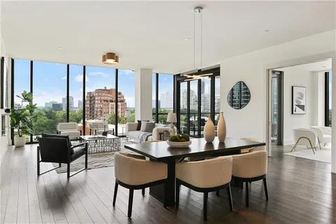 a living room with furniture fireplace and a large window
