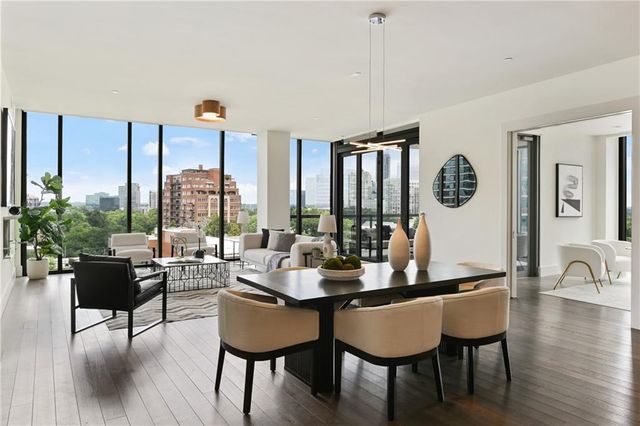 a living room with furniture fireplace and a large window