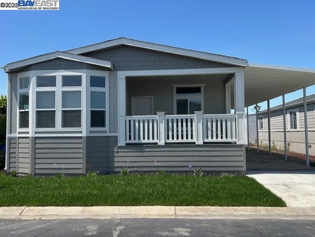 a view of a house with a small yard and wooden fence