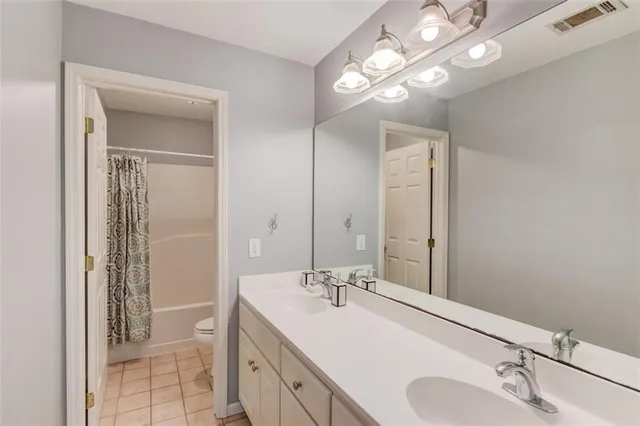 a bathroom with a sink double vanity and a mirror