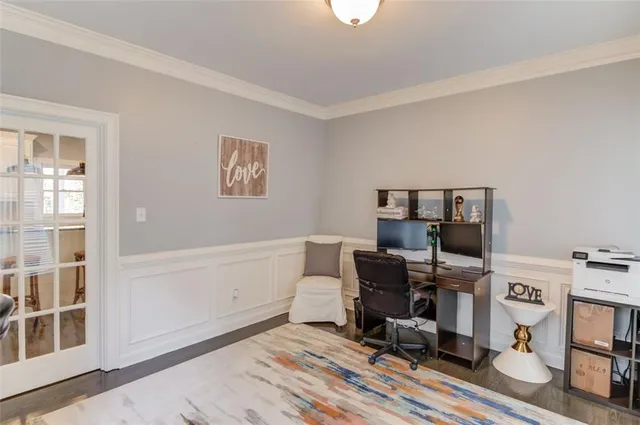 a view of a workspace with furniture and a window