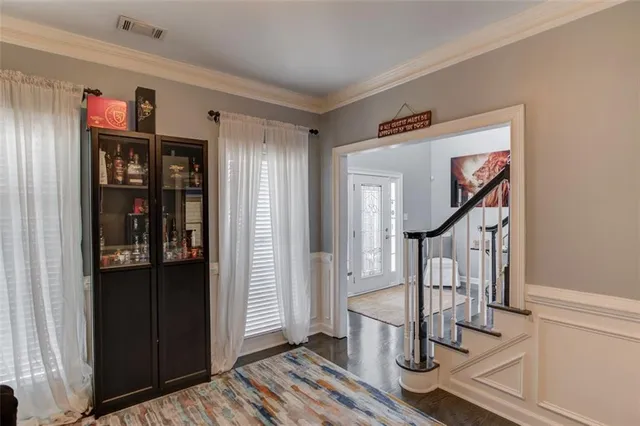a view of entryway with wooden floor and stairs
