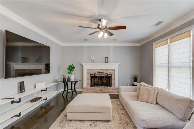 a living room with furniture fireplace and flat screen tv