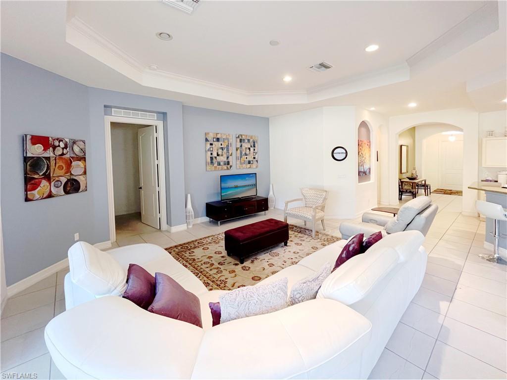 1366 Serrano Circle Naples, FL 34105 - Photo 11 of 30 a living room with furniture and wooden floor