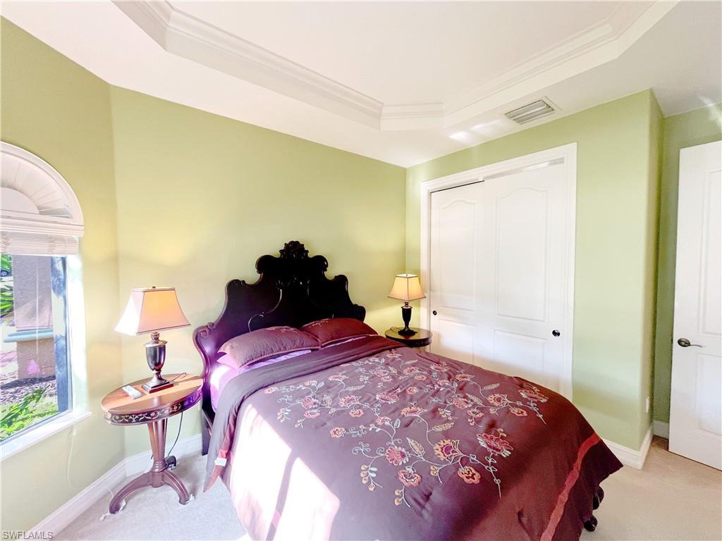 1366 Serrano Circle Naples, FL 34105 - Photo 19 of 30 a bedroom with a bed and a window