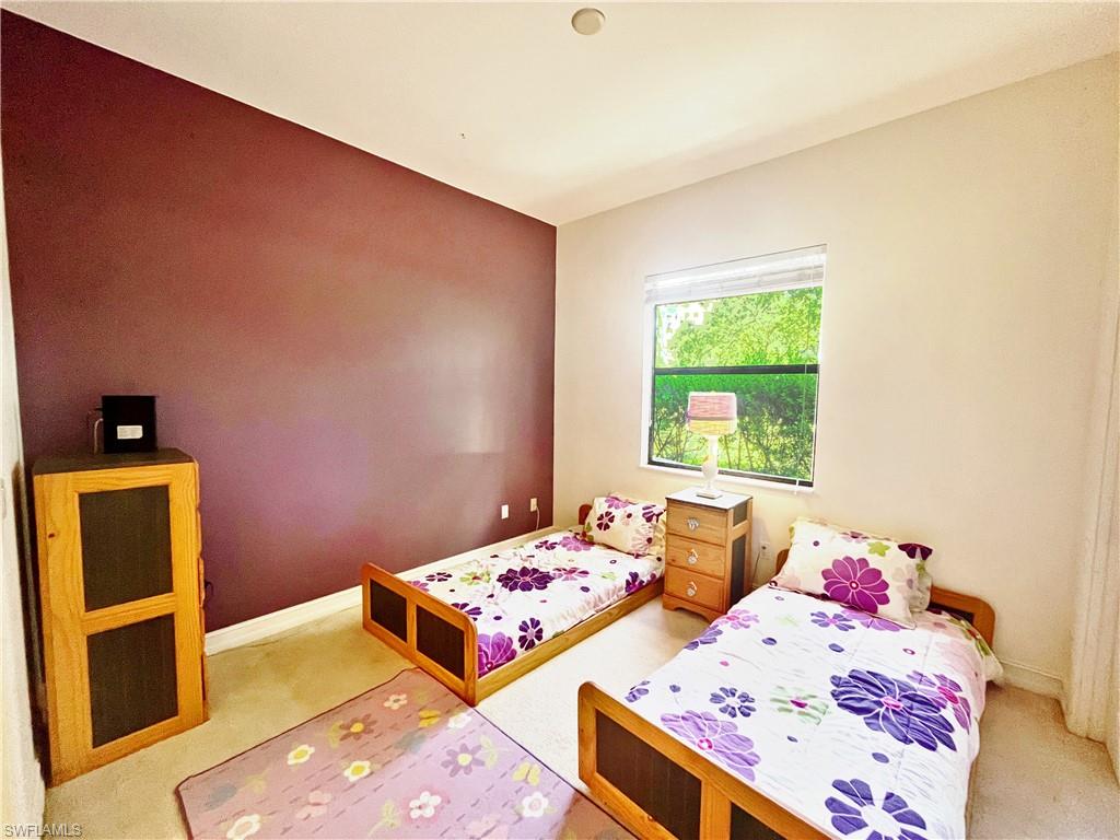 1366 Serrano Circle Naples, FL 34105 - Photo 21 of 30 a bedroom with a bed and a dresser