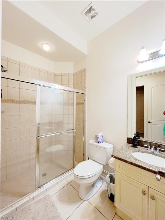 1366 Serrano Circle Naples, FL 34105 - Photo 22 of 30 a bathroom with a granite countertop sink a toilet and shower