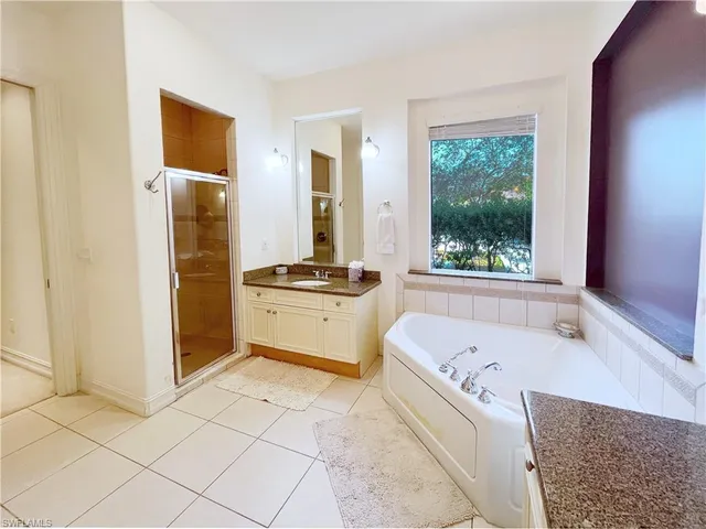 a bathroom with a tub sink and window