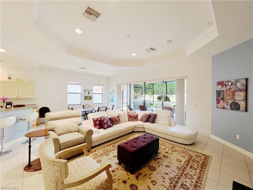 1366 Serrano Circle Naples, FL 34105 - Photo 9 of 30 a living room with furniture or couch and a coffee table