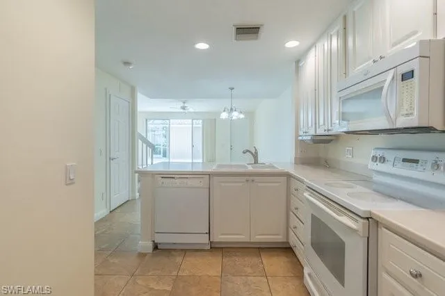a kitchen with a sink cabinets and appliances