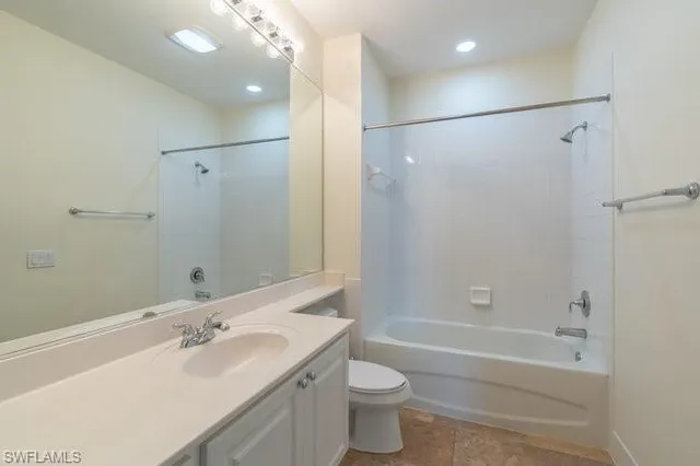 a bathroom with a double vanity sink toilet mirror and shower