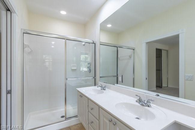 8108 Josefa Way Naples, FL 34114 - Photo 31 of 40 a bathroom with a double vanity sink mirror and shower