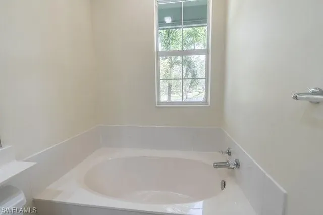a white bath tub sitting next to a window