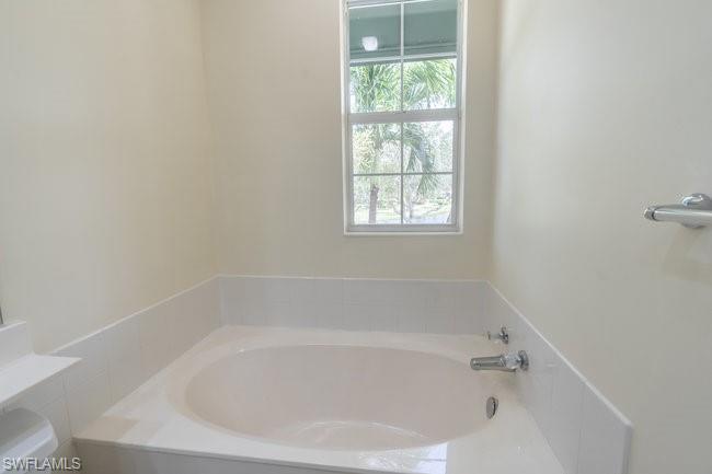 8108 Josefa Way Naples, FL 34114 - Photo 32 of 40 a white bath tub sitting next to a window