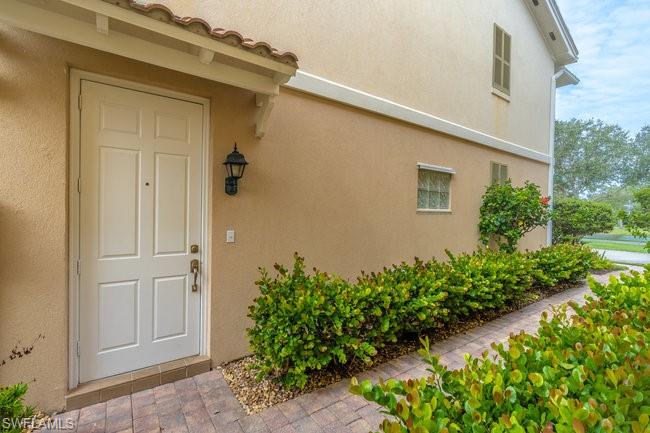 8108 Josefa Way Naples, FL 34114 - Photo 6 of 40 front view of a house with a yard