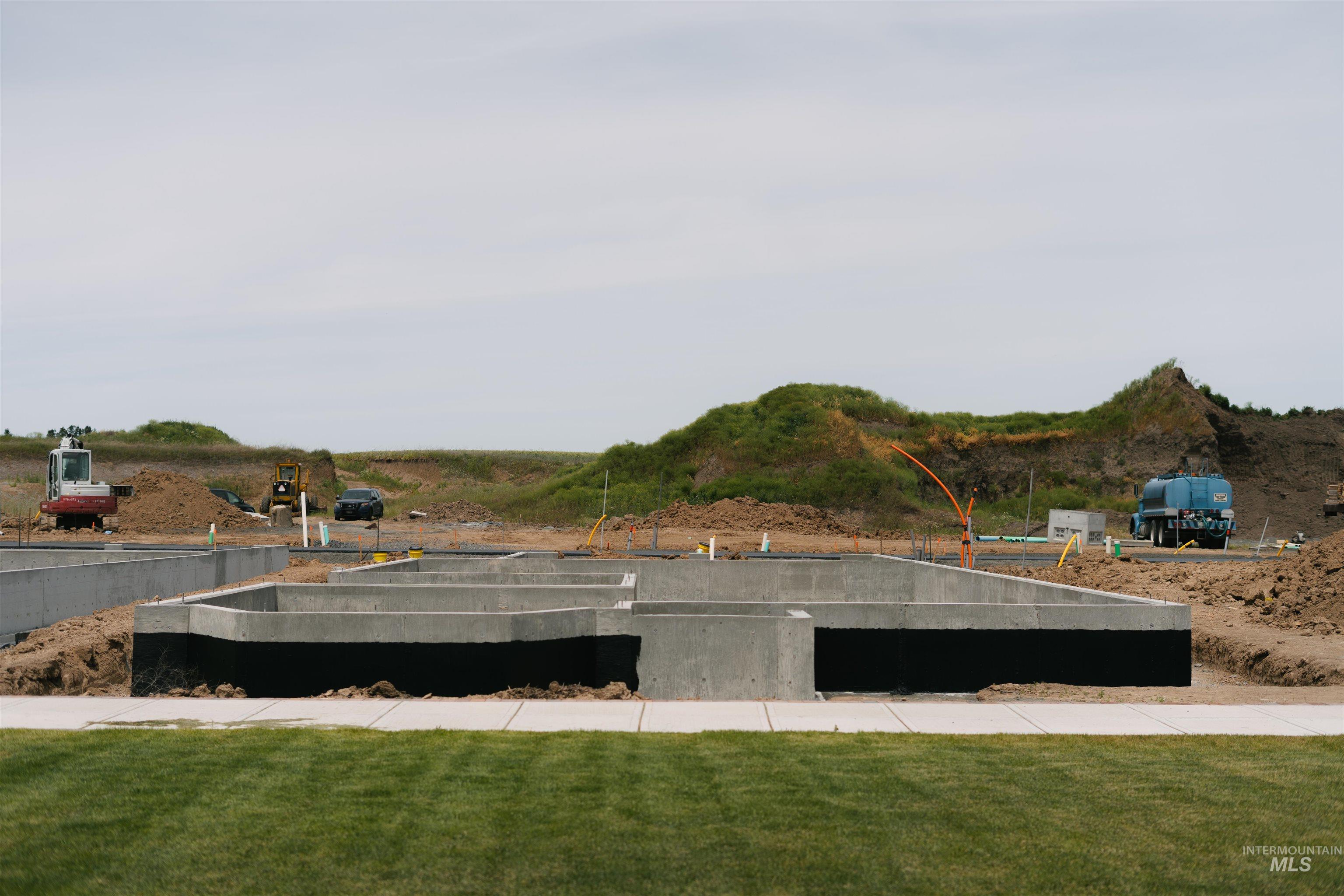 1463 Cottage Lane Moscow, ID 83843 - Photo 8 of 23 Concrete foundation with dark waterproofing membrane, positioned on a level building site