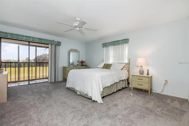 a spacious bedroom with a bed and a large window