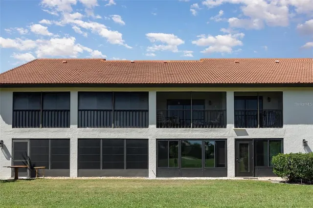 a view of a brick house with a yard