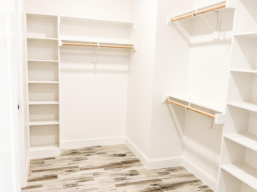201 Bluff Court Godley, TX 76044 - Photo 7 of 15 a view of walk in closet with empty racks