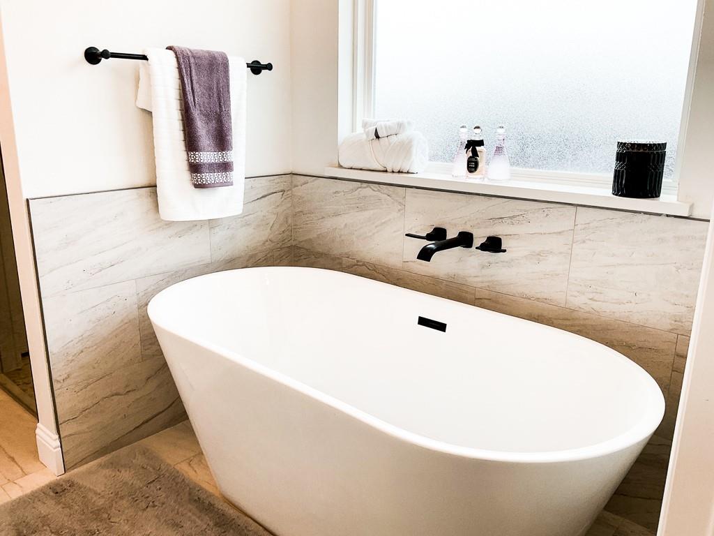 201 Bluff Court Godley, TX 76044 - Photo 8 of 15 a white bath tub sitting in a bathroom