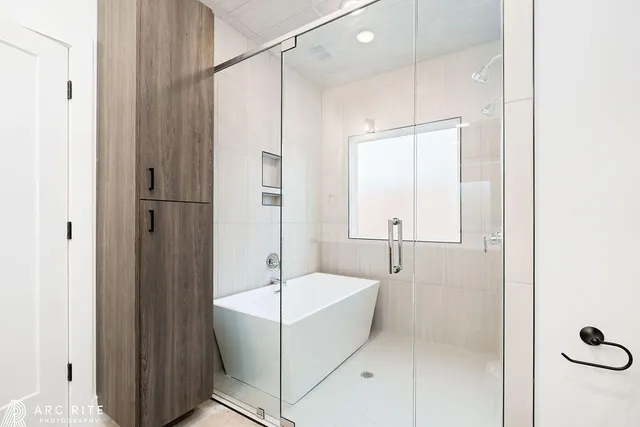 a bathroom with a bathtub and a shower